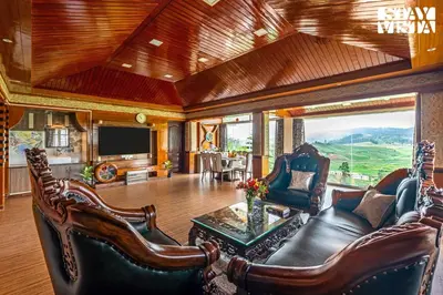 a living room with a couch and chairs and a television at The Secret Glen by VEO - Part of StayVista with BBQ & Bonfire in Ooty
