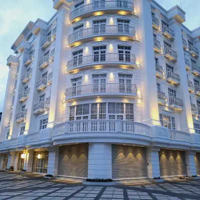a large white building with balconies on it at The Palazzo Chakolas in Trichūr