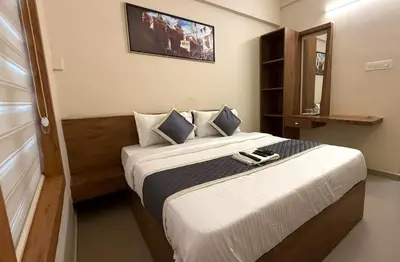 a bedroom with a large bed in a room at Haaz Grande Kunnamangalam in Kunnamangalam