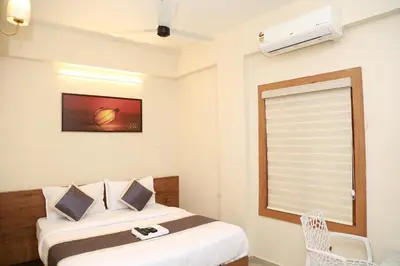 a hotel room with a bed and a window at Haaz Grande Kunnamangalam in Kunnamangalam