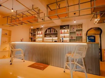 a bar with two chairs and a counter in a store at Whitelake Resort in Bilikere