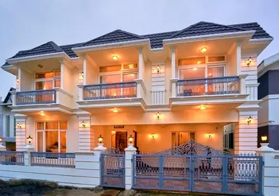 a large white house with a balcony at King Palace Ooty by VOYE HOMES in Ooty