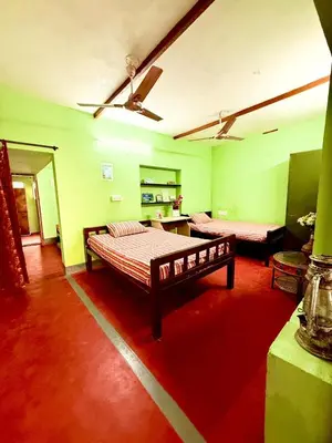 a room with a bed and a couch in it at GSC Family Holiday Home in Pollāchi