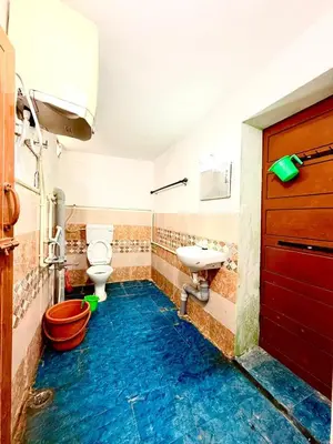 a bathroom with a toilet and a sink at GSC Family Holiday Home in Pollāchi