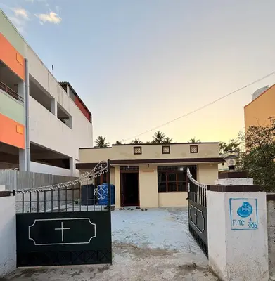 a building with a gate in front of it at GSC Family Cottage in Samattūr
