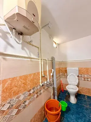 a small bathroom with a toilet and a shower at GSC Family Cottage in Samattūr