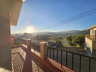 a view from the balcony of a house at Sait's Westhill View Resort in Ooty