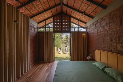 a bedroom with a bed and a large window at Tranquil Nest in Kozhikode