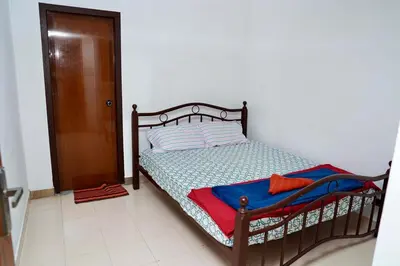 a bedroom with a bed with a wooden frame at Aroha Residence - Sleek and Spacious Wayanad Villa in Kalpetta