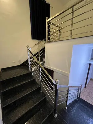 a set of stairs in a building at Aroha Residence - Sleek and Spacious Wayanad Villa in Kalpetta