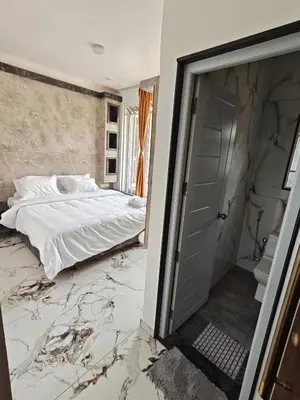 a bedroom with a bed and a marble floor at The Ooty Suites in Ooty