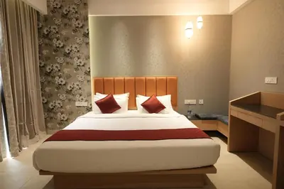 a bedroom with a large bed in a room at Hotel Cachet in Coimbatore