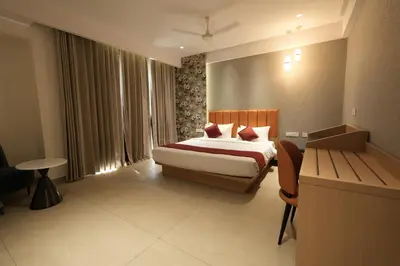 a bedroom with a bed and a desk in a room at Hotel Cachet in Coimbatore