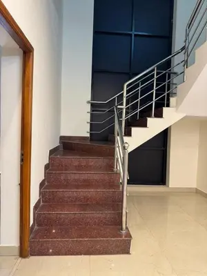 a set of stairs in a building with a blue door at Marvee Luxus Stay in Coimbatore