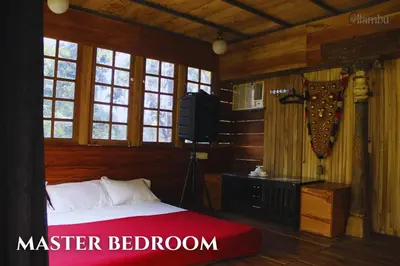 a bedroom with a bed and a tv in it at Nilambu Homestay in Nilambūr