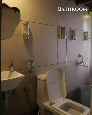 a bathroom with a toilet and a sink at Nilambu Homestay in Nilambūr