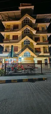 a building with a black fence in front of it at Sree guruvayoorappan inn in Guruvāyūr