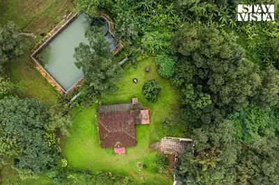 an aerial view of a park with a pond at The Fig Tree Villa by VEO - Part of StayVista in Madikeri