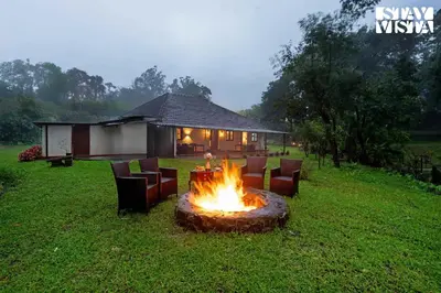 a fire pit in the middle of a yard at The Fig Tree Villa by VEO - Part of StayVista in Madikeri