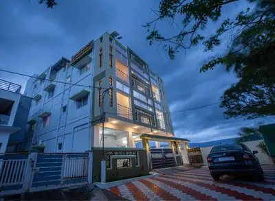 a building with a car parked in front of it at Sree Bharat Apartment in Coimbatore