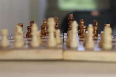 a chess board with wooden chess pieces on it at bohom STAYORA in Nedumbassery
