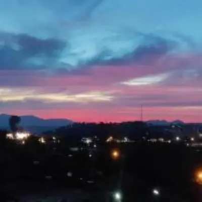 a view of a city with a pink and blue sky at Coorg mansion in Madikeri