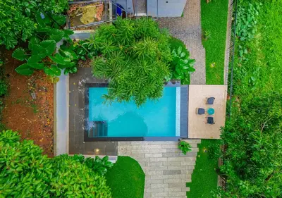 an overhead view of a swimming pool surrounded by trees at Alaya Boutique Villa with Dam View by VOYE HOMES in Vythiri