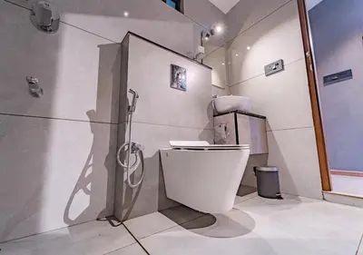 a bathroom with a toilet and a shower at Alaya Boutique Villa with Dam View by VOYE HOMES in Vythiri