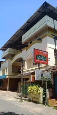 a building with a sign in front of it at Mahe Residency in Mahe