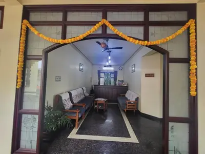 an entrance to a room with an orange garland at Mahe Residency in Mahe