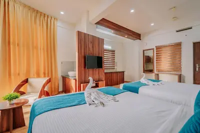 a bedroom with two beds with stuffed animals on them at D Nest Inn in Trichūr