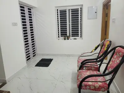 a room with two chairs and two windows at Zirku Garden Kodaikanal in Kodaikānāl