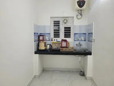 a kitchen counter with a sink in a room at Zirku Garden Kodaikanal in Kodaikānāl