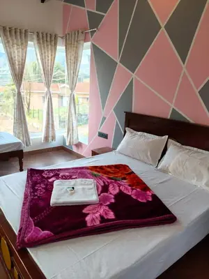 a bedroom with a bed with a purple blanket on it at Westhill Daffodils Inn - II Ooty in Ooty