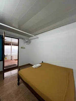 a bedroom with a bed with a phone on it at Relax inn cherai beach in Cochin