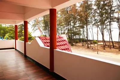 a balcony with a view of the ocean and trees at Relax inn cherai beach in Cochin