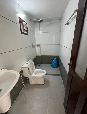 a small bathroom with a toilet and a sink at Relax inn cherai beach in Cochin