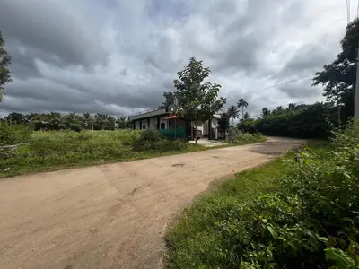 a dirt road with a house on the side of it at Kannada Maathe Home Stay- Golden Temple-Tibet camp 2 km far in Kushālnagar