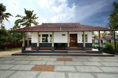 a small house with a tile roof at Dhruv Heritage Lake Resort Cherai in Cochin