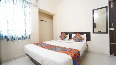 a bedroom with a large bed in a room at Honey Residency Codissia stay in Coimbatore