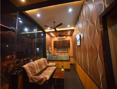 a living room with a couch and a table at PRM Aruna Lodge in Erode