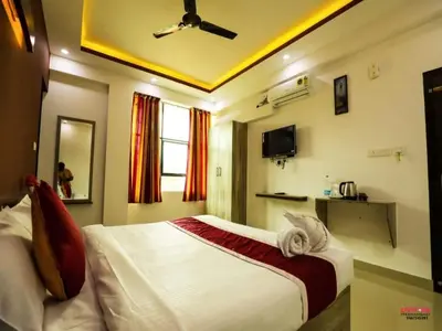a bedroom with a large bed in a room at J TEN Residency in Meenangadi