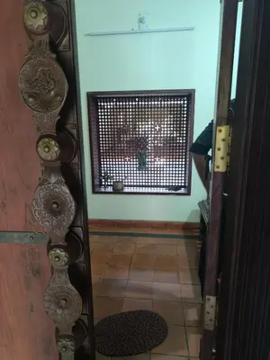 an open door to a room with a window at Utthara Tharavadu in Irinjālakuda