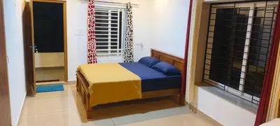 a small bedroom with a bed and a window at Wayanad Home stay in Kaniyāmbetta