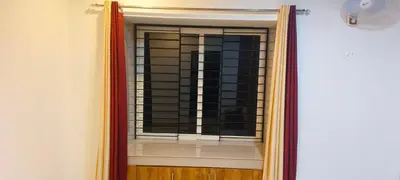 a mirror in a room with a window at Wayanad Home stay in Kaniyāmbetta
