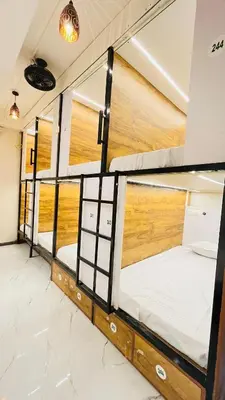 a row of bunk beds in a room at LF Hotels in Kozhikode
