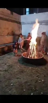 a group of people sitting around a fire pit at HILL view ooty HOME Stay in Coimbatore