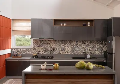 a kitchen with black cabinets and a counter with melons on it at Hillside Home 3 BHK Villa by tisyastays in Yedapalli
