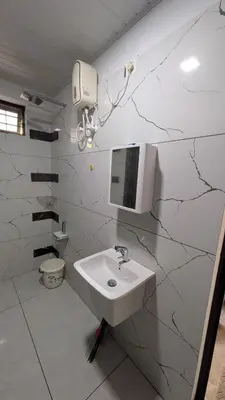 a white bathroom with a sink and a mirror at village stay Chittur Thathamangalam in Tattamangalam