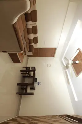 a room with a staircase with wooden ceiling at LAVENDER AiRPORT SUiTE in Nedumbassery